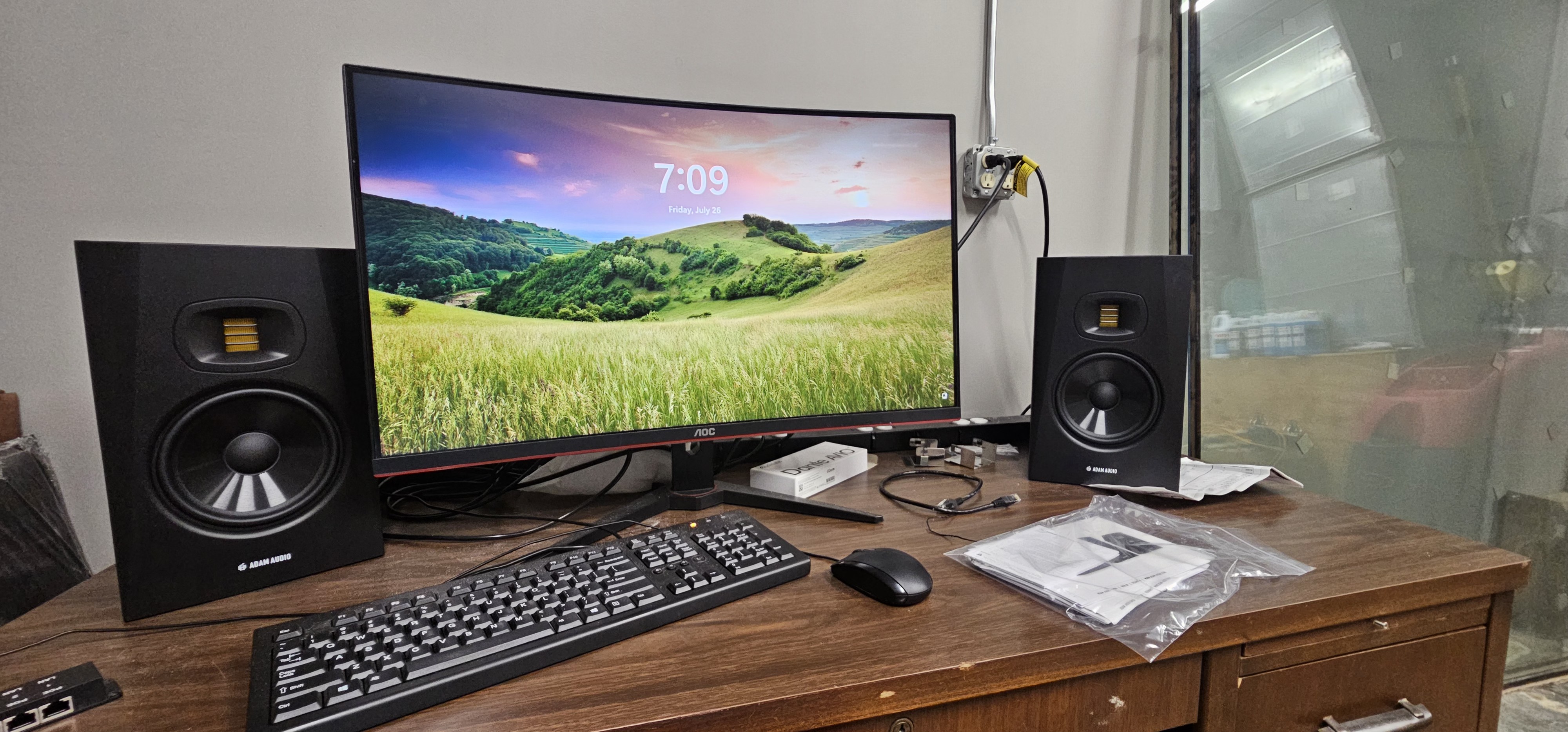 Workstation desk with studio monitors and networked audio equipment